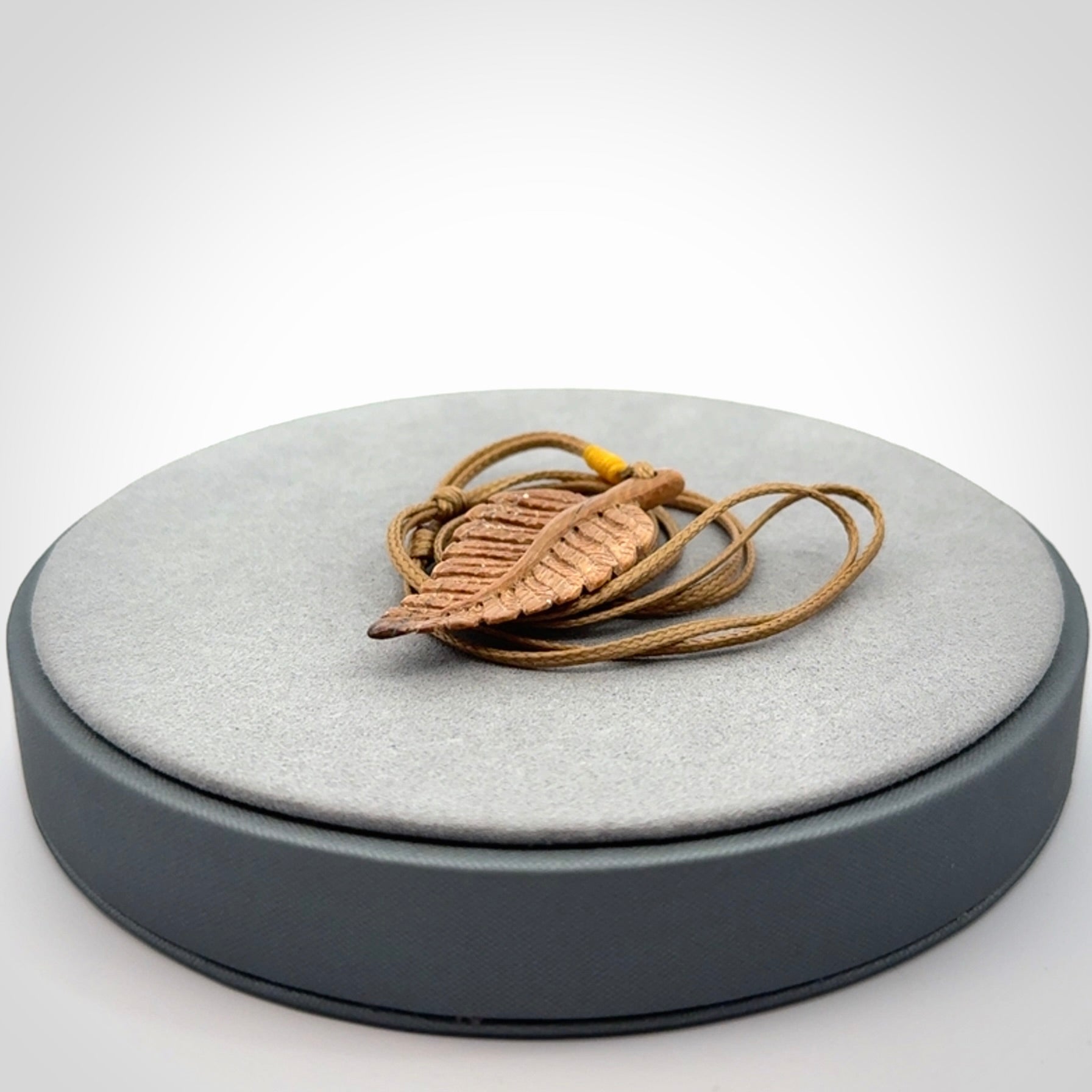 Hand carved woolly mammoth tusk fern pendant. Made in New Zealand. Unique hand made gifts from NZ Pacific. Hand carved fern necklace from ancient woolly mammoth tusk.
