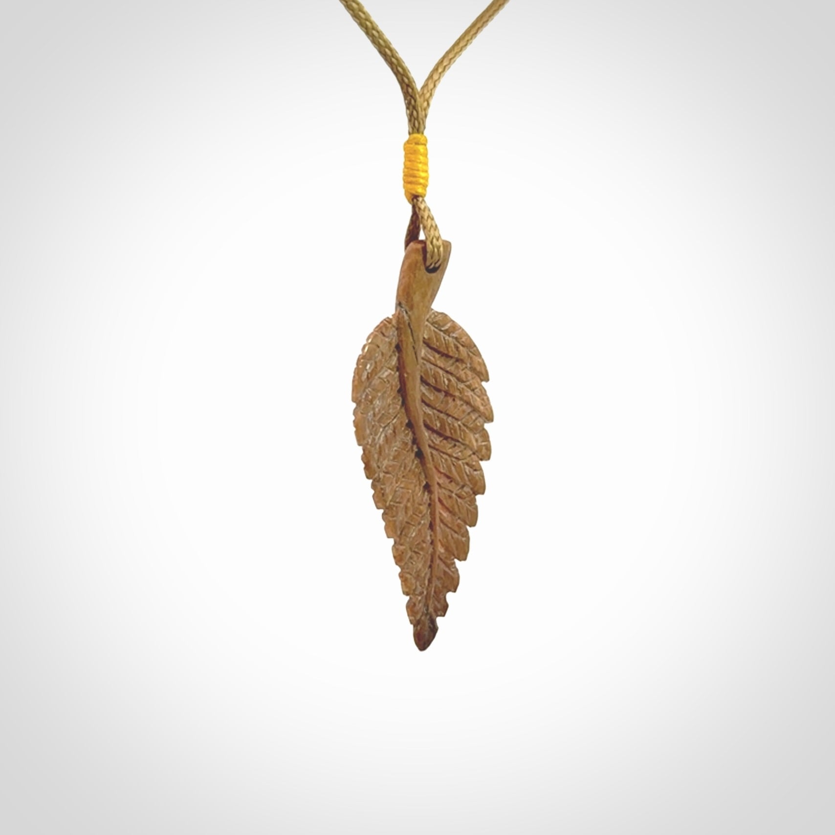 Hand carved woolly mammoth tusk fern pendant. Made in New Zealand. Unique hand made gifts from NZ Pacific. Hand carved fern necklace from ancient woolly mammoth tusk.
