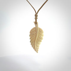 Hand carved woolly mammoth tusk fern pendant. Made in New Zealand. Unique hand made gifts from NZ Pacific. Hand carved fern necklace from ancient woolly mammoth tusk.