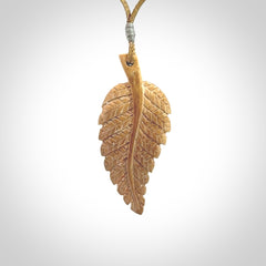 Hand carved woolly mammoth tusk fern pendant. Made in New Zealand. Unique hand made gifts from NZ Pacific. Hand carved fern necklace from ancient woolly mammoth tusk.