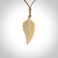 Hand carved woolly mammoth tusk fern pendant. Made in New Zealand. Unique hand made gifts from NZ Pacific. Hand carved fern necklace from ancient woolly mammoth tusk.