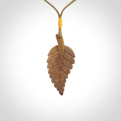 Hand carved woolly mammoth tusk fern pendant. Made in New Zealand. Unique hand made gifts from NZ Pacific. Hand carved fern necklace from ancient woolly mammoth tusk.