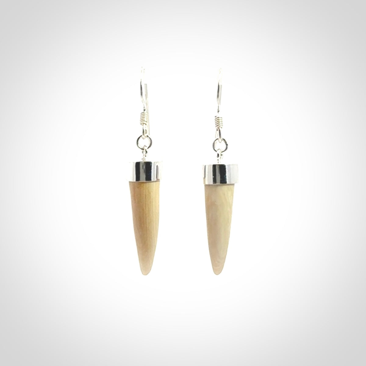Hand made mammoth tusk drop earrings. Made by NZ Pacific - handmade jewellery for sale online. Woolly Mammoth Tusk fang style earrings, packaged in a woven kete pouch.