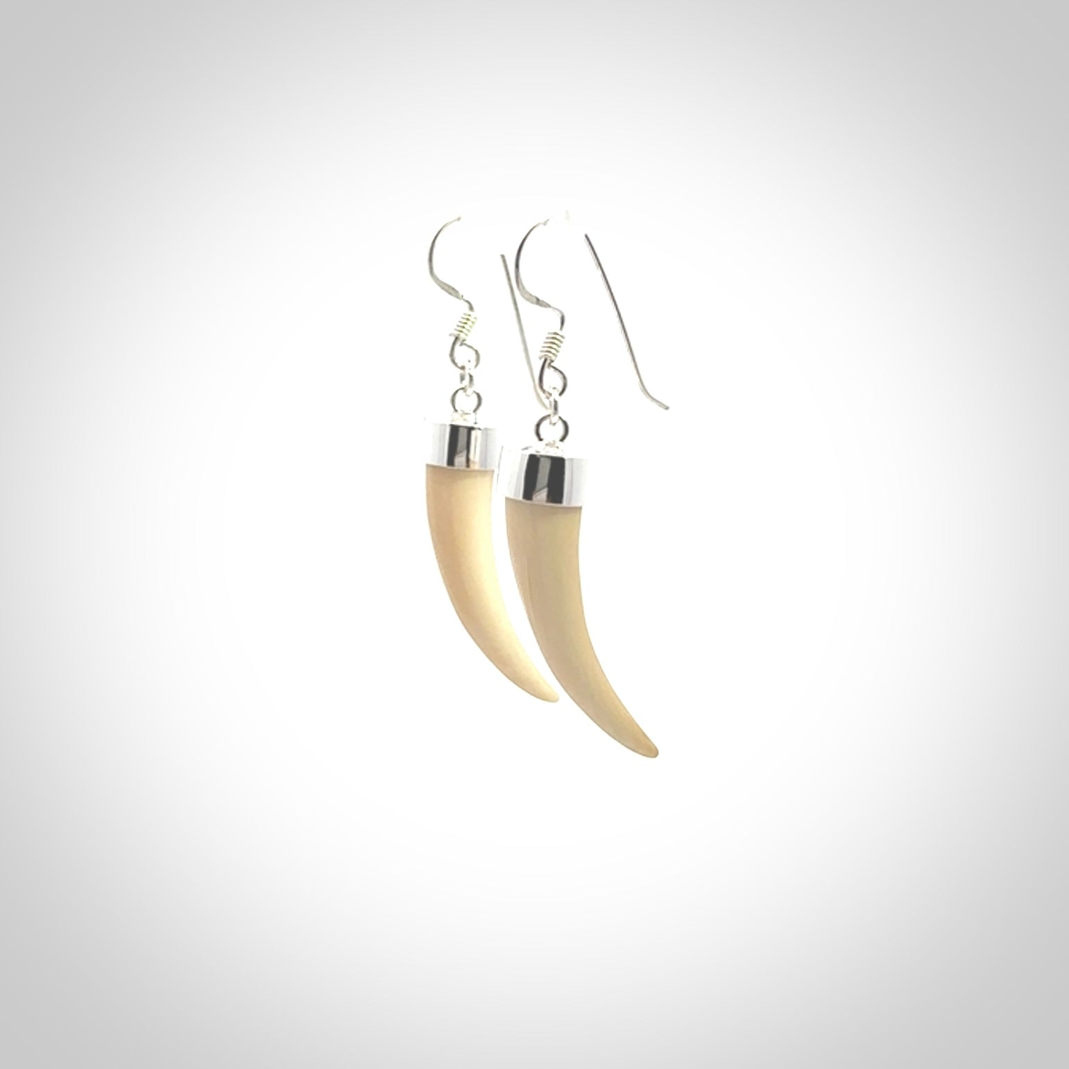Hand made mammoth tusk drop earrings. Made by NZ Pacific - handmade jewellery for sale online. Woolly Mammoth Tusk fang style earrings, packaged in a woven kete pouch.