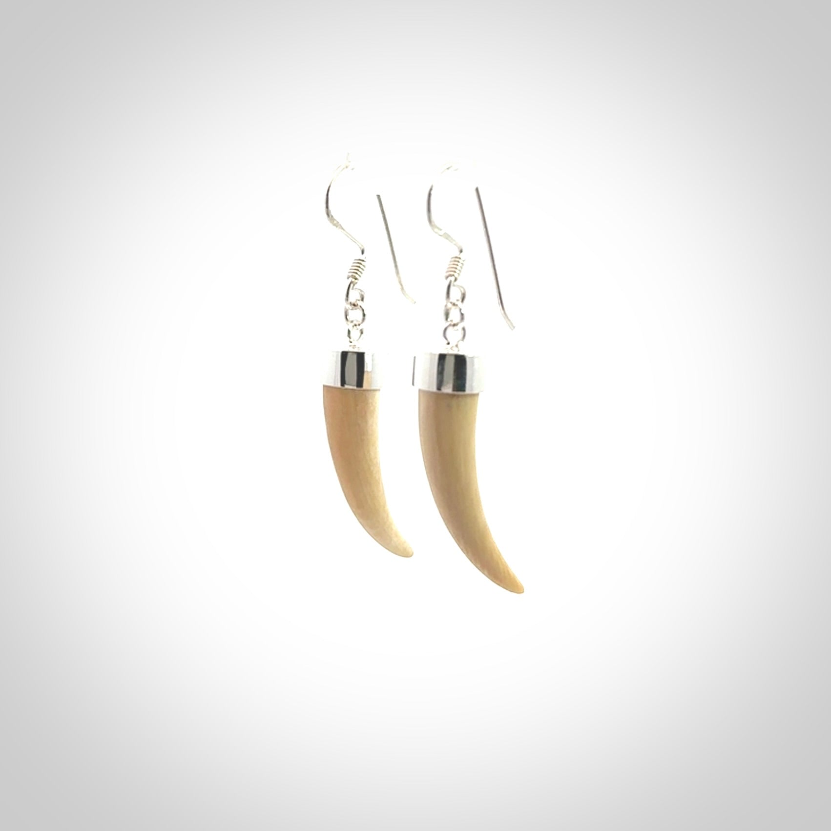Hand made mammoth tusk drop earrings. Made by NZ Pacific - handmade jewellery for sale online. Woolly Mammoth Tusk fang style earrings, packaged in a woven kete pouch.