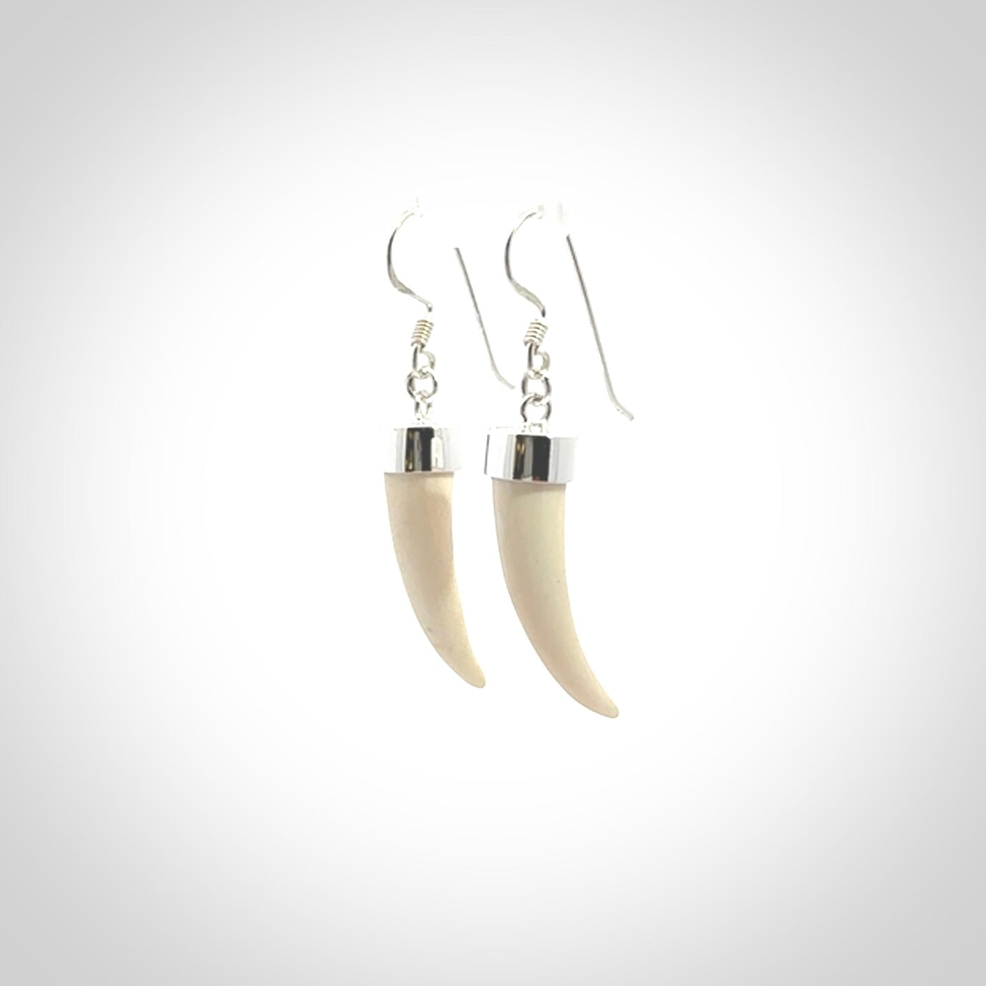 Hand made mammoth tusk drop earrings. Made by NZ Pacific - handmade jewellery for sale online. Woolly Mammoth Tusk fang style earrings, packaged in a woven kete pouch.