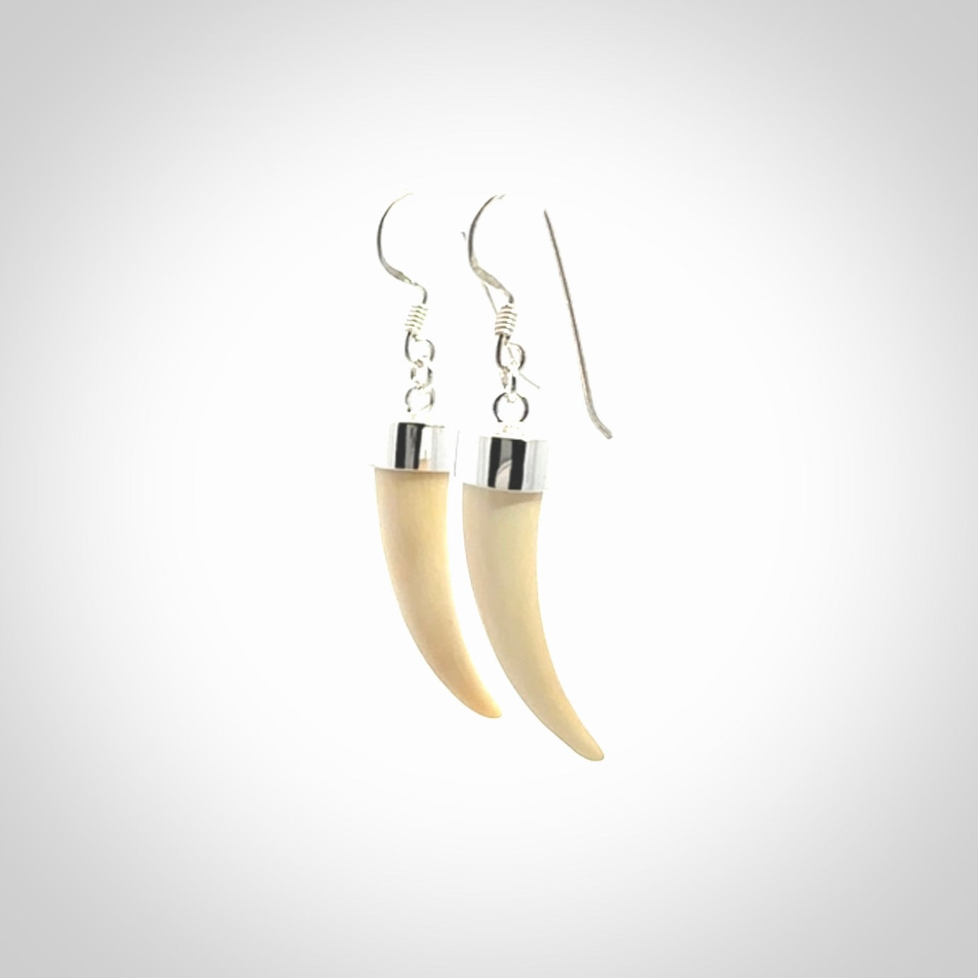 Hand made mammoth tusk drop earrings. Made by NZ Pacific - handmade jewellery for sale online. Woolly Mammoth Tusk fang style earrings, packaged in a woven kete pouch.