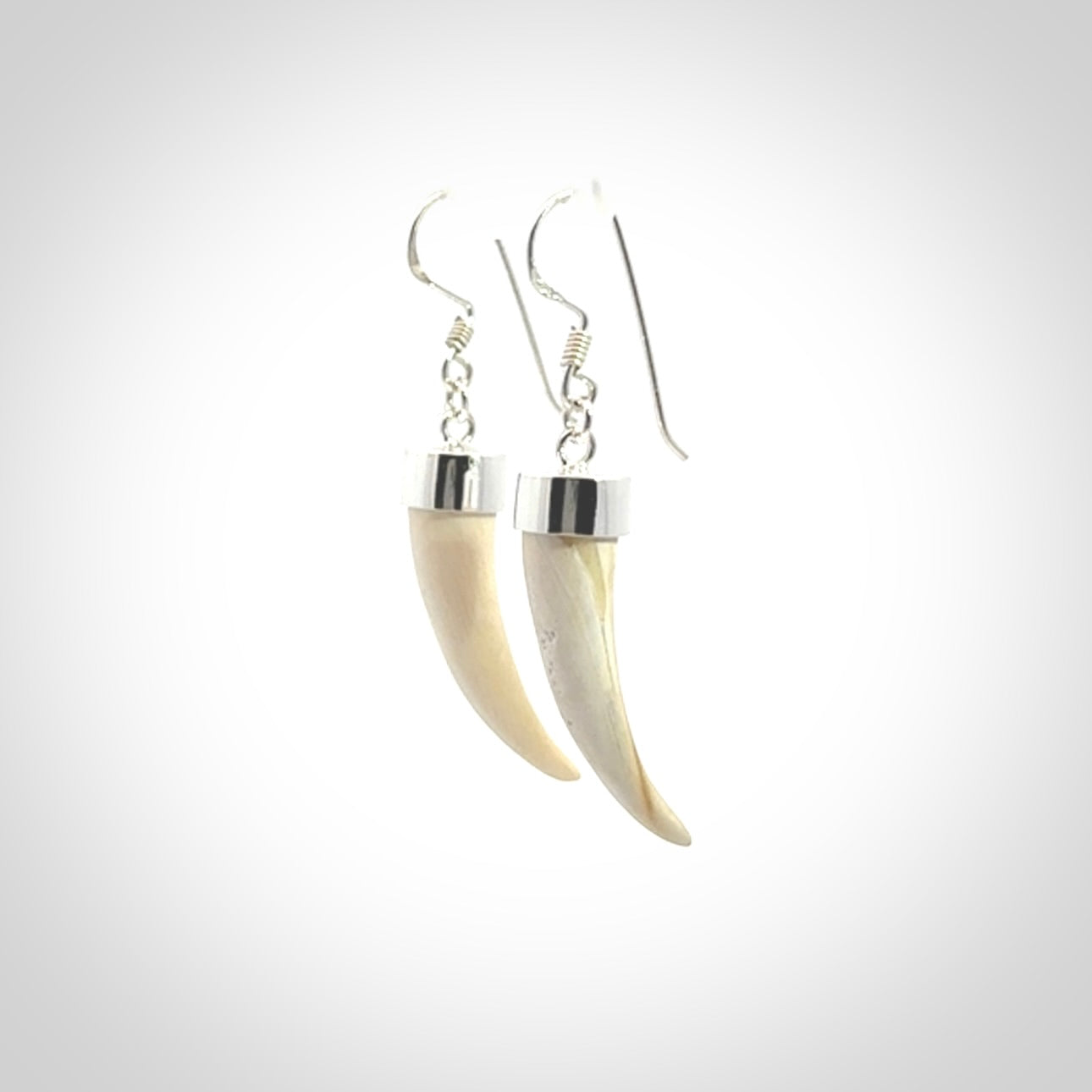 Hand made mammoth tusk drop earrings. Made by NZ Pacific - handmade jewellery for sale online. Woolly Mammoth Tusk fang style earrings, packaged in a woven kete pouch.