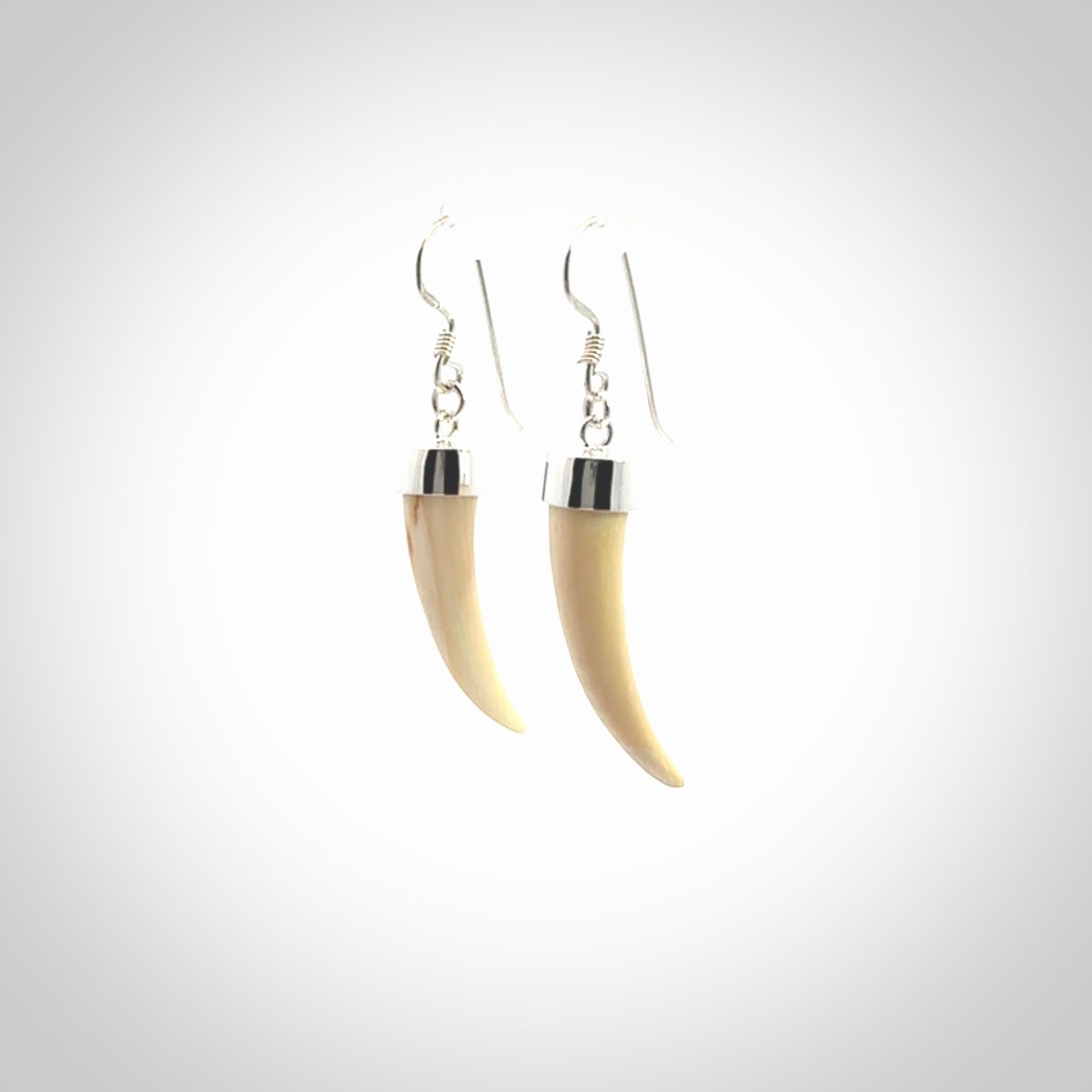 Hand made mammoth tusk drop earrings. Made by NZ Pacific - handmade jewellery for sale online. Woolly Mammoth Tusk fang style earrings, packaged in a woven kete pouch.