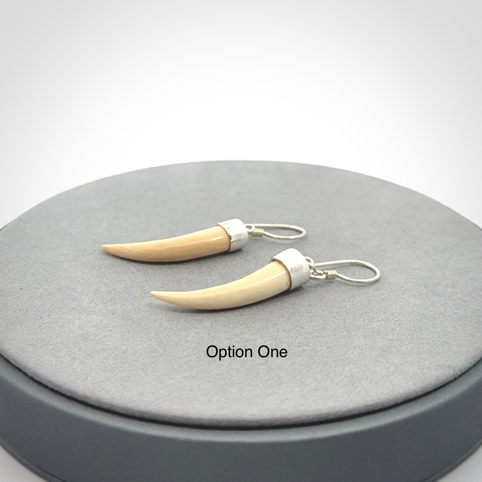 Hand made mammoth tusk drop earrings. Made by NZ Pacific - handmade jewellery for sale online. Woolly Mammoth Tusk fang style earrings, packaged in a woven kete pouch.