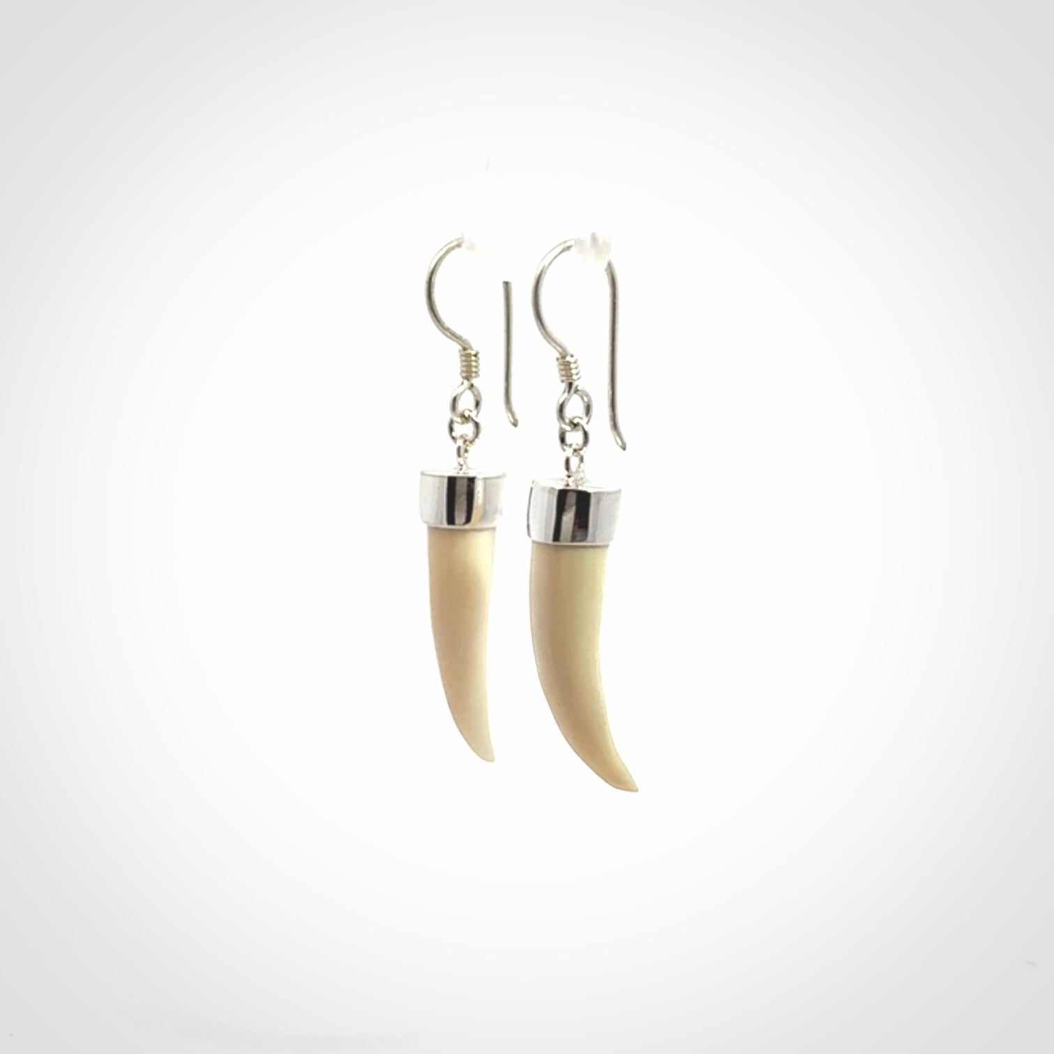 Hand made mammoth tusk drop earrings. Made by NZ Pacific - handmade jewellery for sale online. Woolly Mammoth Tusk fang style earrings, packaged in a woven kete pouch.