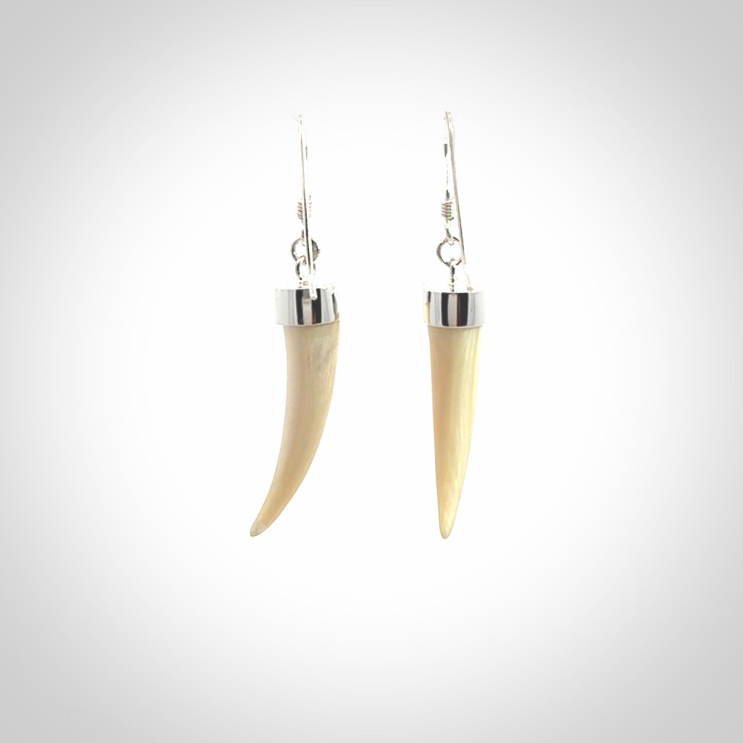Hand made mammoth tusk drop earrings. Made by NZ Pacific - handmade jewellery for sale online. Woolly Mammoth Tusk fang style earrings, packaged in a woven kete pouch.