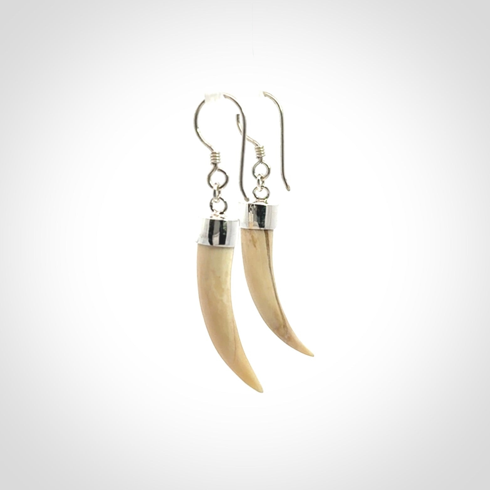 Hand made mammoth tusk drop earrings. Made by NZ Pacific - handmade jewellery for sale online. Woolly Mammoth Tusk fang style earrings, packaged in a woven kete pouch.