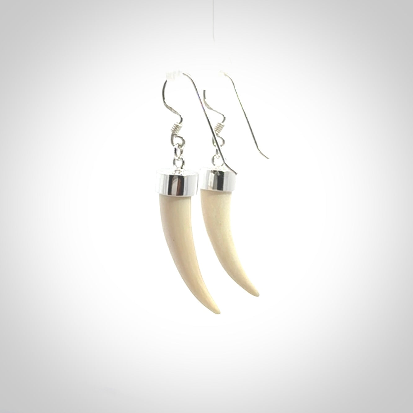 Hand made mammoth tusk drop earrings. Made by NZ Pacific - handmade jewellery for sale online. Woolly Mammoth Tusk fang style earrings, packaged in a woven kete pouch.