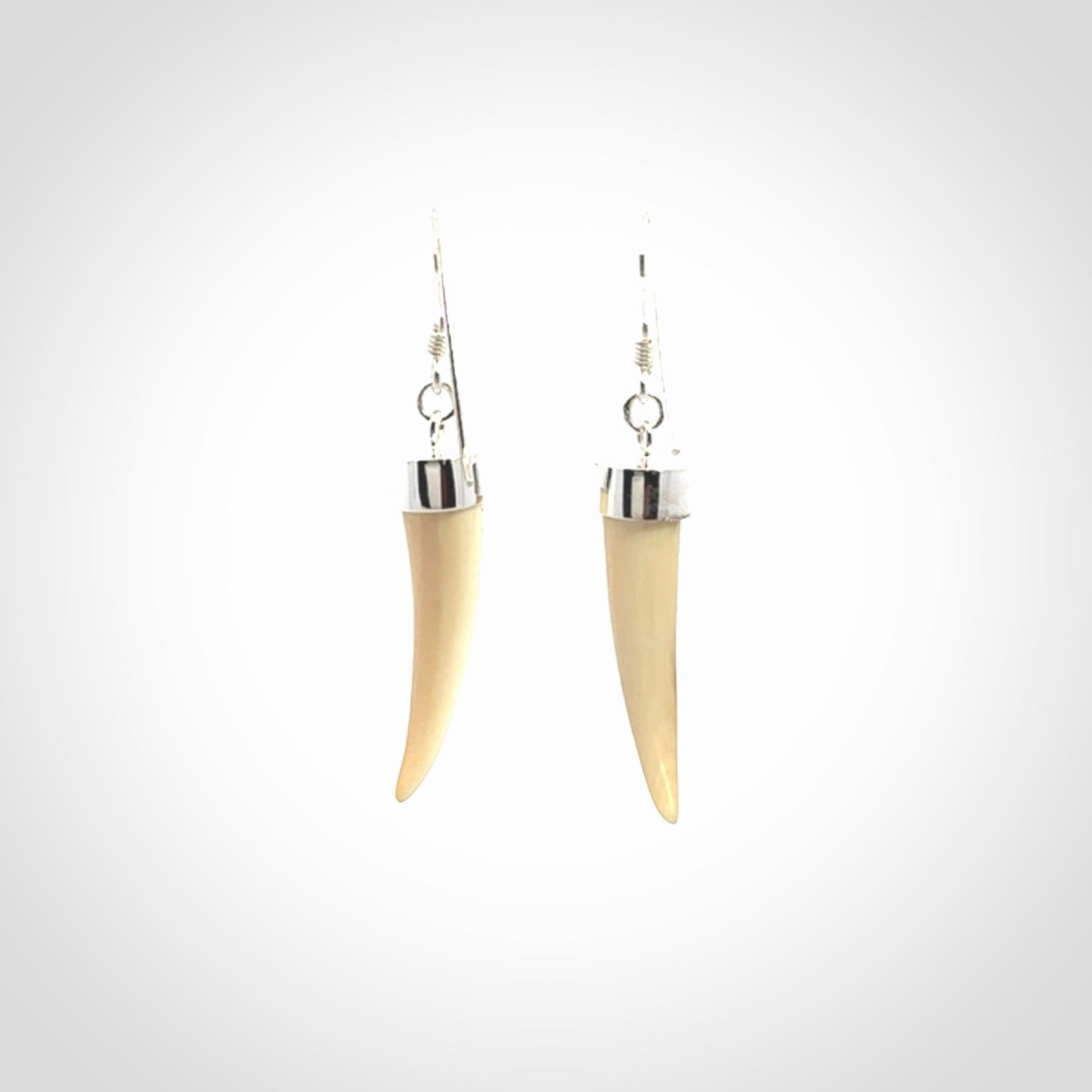 Hand made mammoth tusk drop earrings. Made by NZ Pacific - handmade jewellery for sale online. Woolly Mammoth Tusk fang style earrings, packaged in a woven kete pouch.