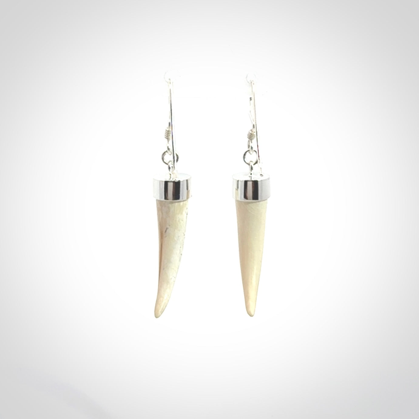 Hand made mammoth tusk drop earrings. Made by NZ Pacific - handmade jewellery for sale online. Woolly Mammoth Tusk fang style earrings, packaged in a woven kete pouch.
