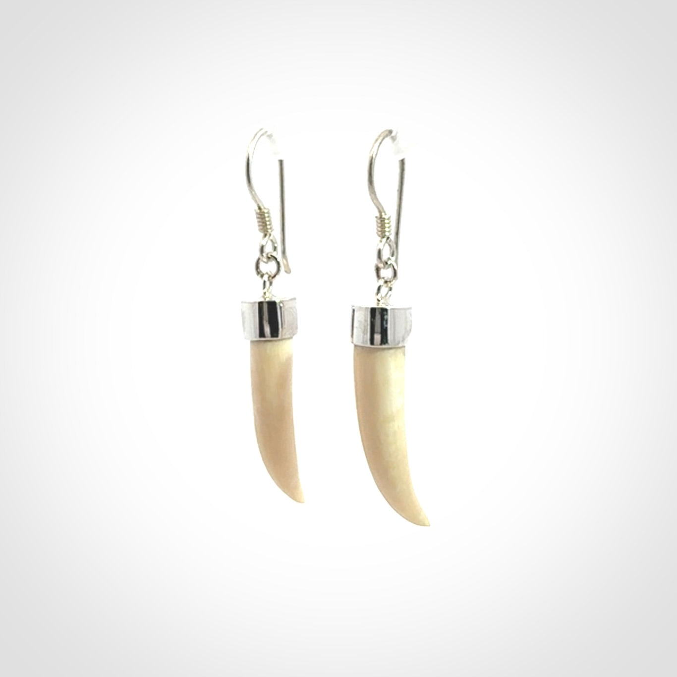 Hand made mammoth tusk drop earrings. Made by NZ Pacific - handmade jewellery for sale online. Woolly Mammoth Tusk fang style earrings, packaged in a woven kete pouch.