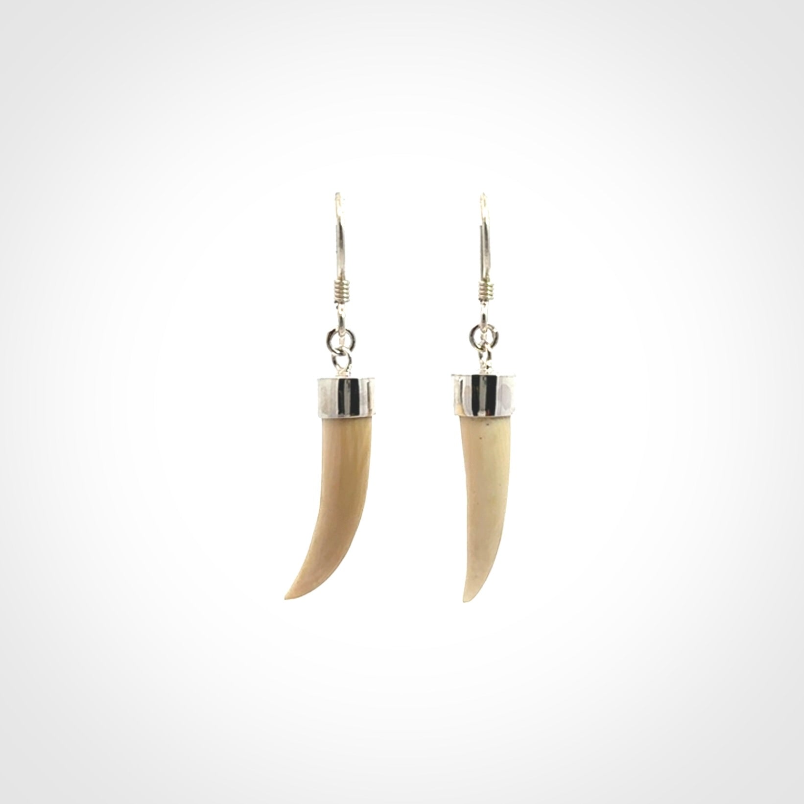 Hand made mammoth tusk drop earrings. Made by NZ Pacific - handmade jewellery for sale online. Woolly Mammoth Tusk fang style earrings, packaged in a woven kete pouch.