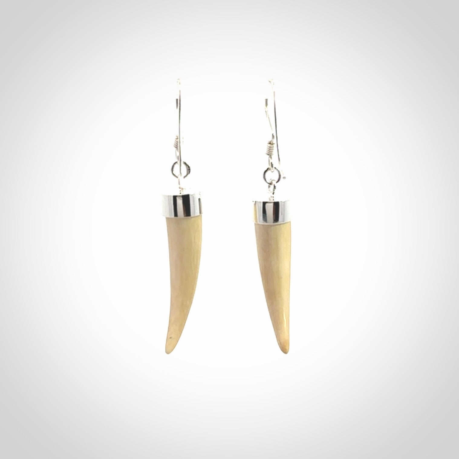 Hand made mammoth tusk drop earrings. Made by NZ Pacific - handmade jewellery for sale online. Woolly Mammoth Tusk fang style earrings, packaged in a woven kete pouch.