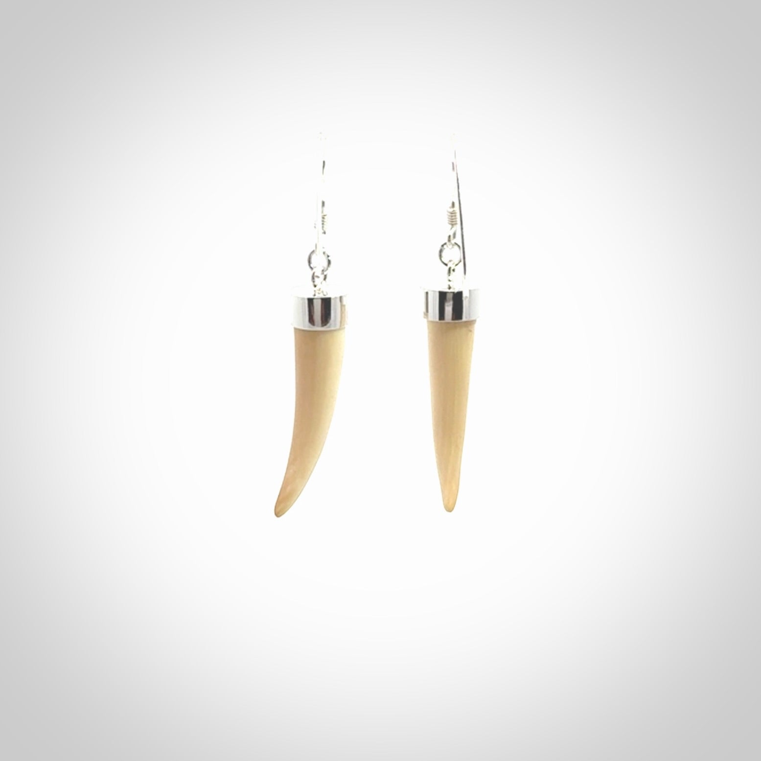 Hand made mammoth tusk drop earrings. Made by NZ Pacific - handmade jewellery for sale online. Woolly Mammoth Tusk fang style earrings, packaged in a woven kete pouch.