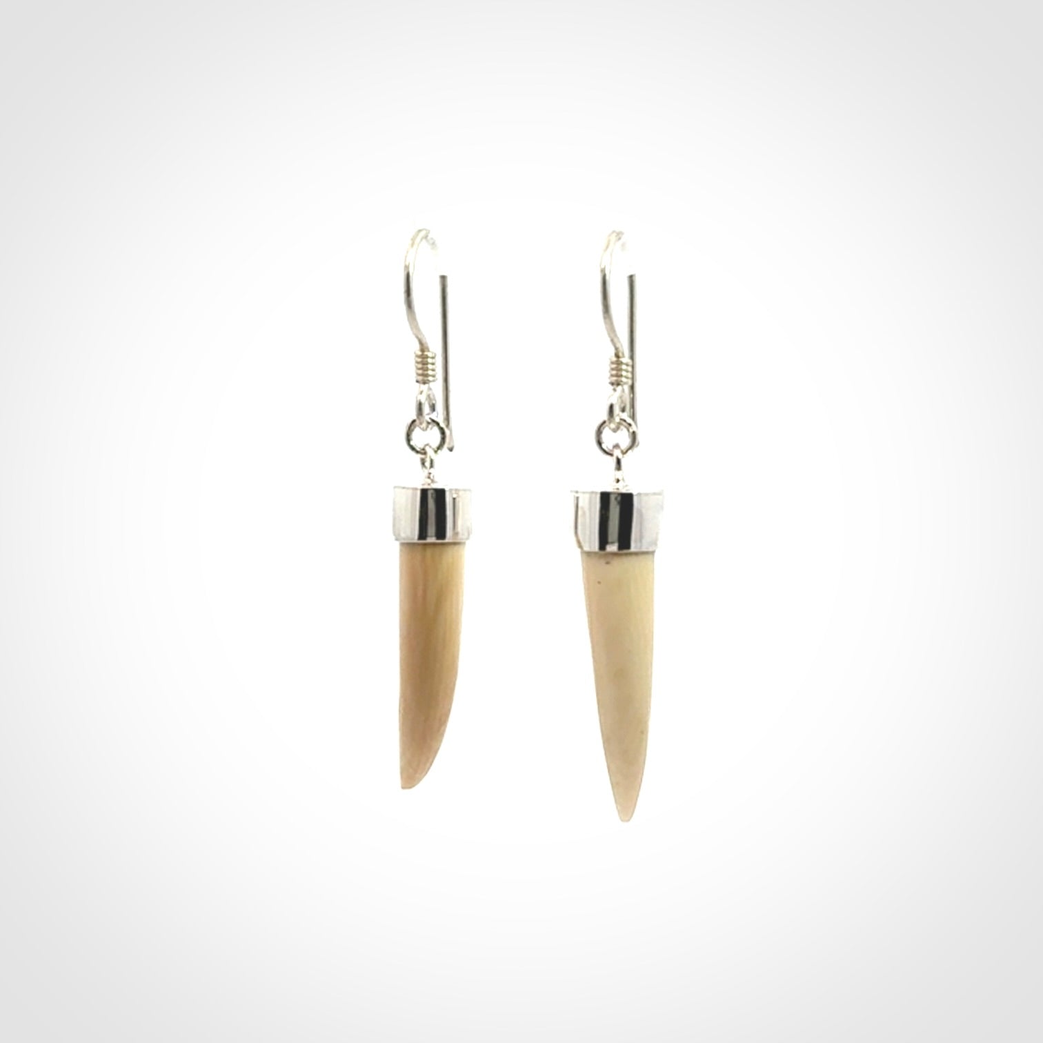 Hand made mammoth tusk drop earrings. Made by NZ Pacific - handmade jewellery for sale online. Woolly Mammoth Tusk fang style earrings, packaged in a woven kete pouch.