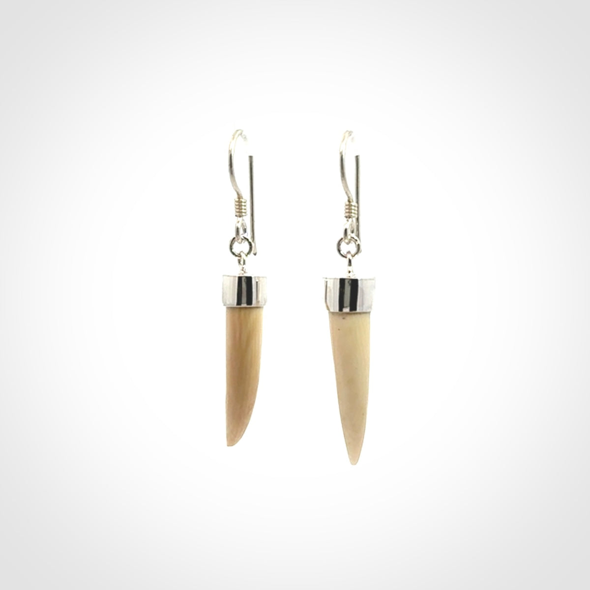 Hand made mammoth tusk drop earrings. Made by NZ Pacific - handmade jewellery for sale online. Woolly Mammoth Tusk fang style earrings, packaged in a woven kete pouch.