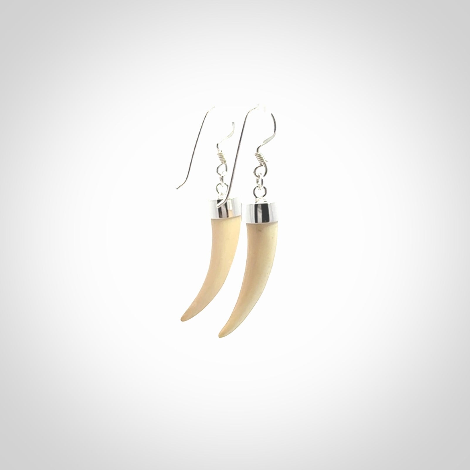 Hand made mammoth tusk drop earrings. Made by NZ Pacific - handmade jewellery for sale online. Woolly Mammoth Tusk fang style earrings, packaged in a woven kete pouch.