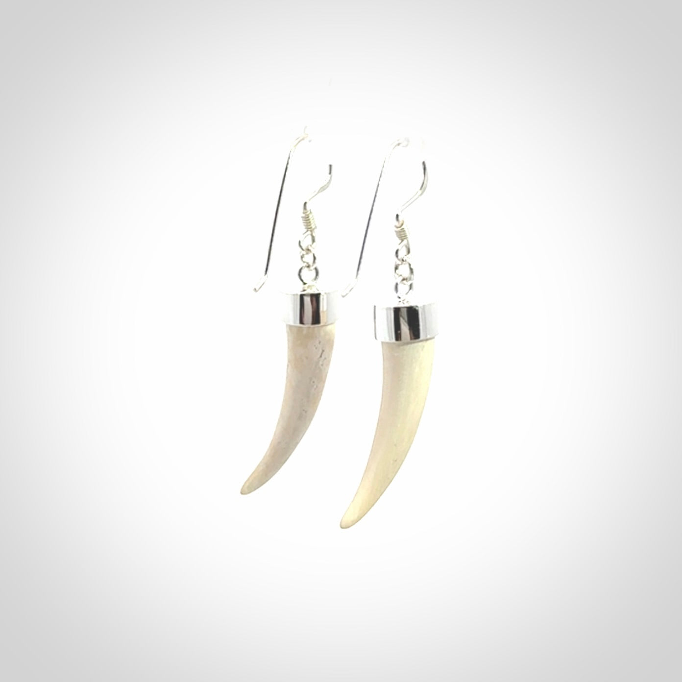 Hand made mammoth tusk drop earrings. Made by NZ Pacific - handmade jewellery for sale online. Woolly Mammoth Tusk fang style earrings, packaged in a woven kete pouch.