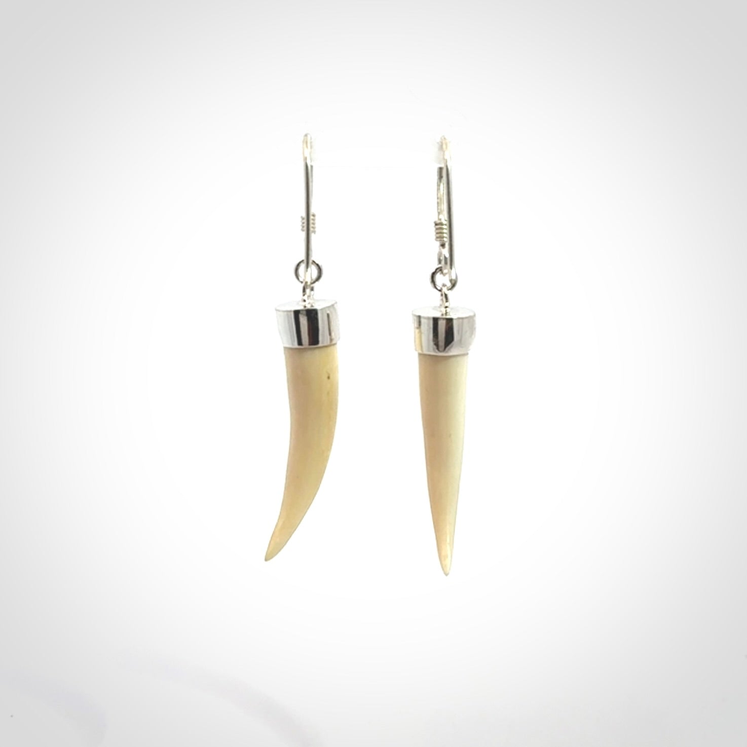 Hand made mammoth tusk drop earrings. Made by NZ Pacific - handmade jewellery for sale online. Woolly Mammoth Tusk fang style earrings, packaged in a woven kete pouch.