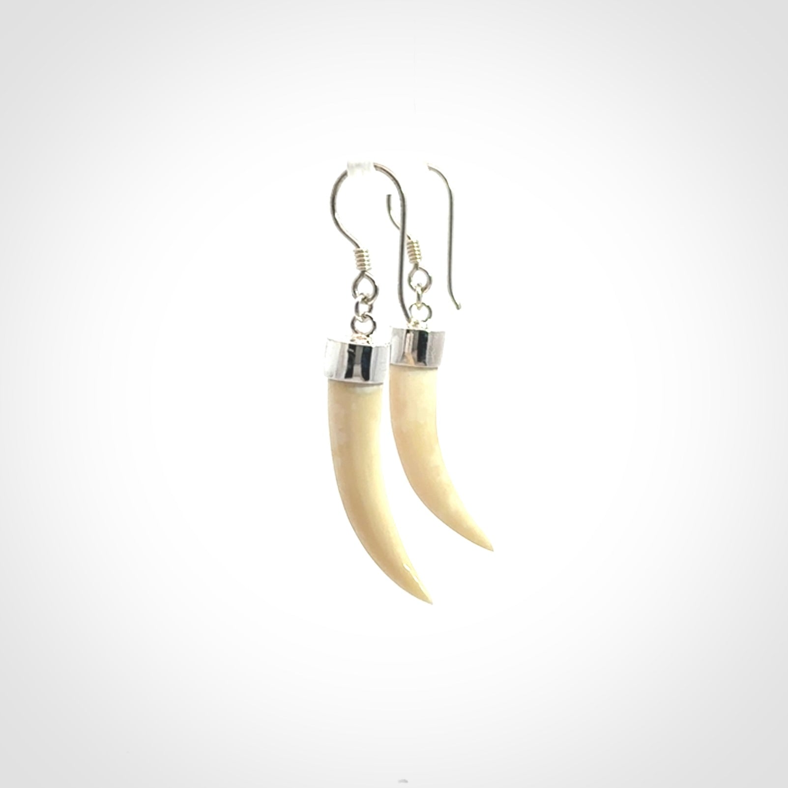 Hand made mammoth tusk drop earrings. Made by NZ Pacific - handmade jewellery for sale online. Woolly Mammoth Tusk fang style earrings, packaged in a woven kete pouch.