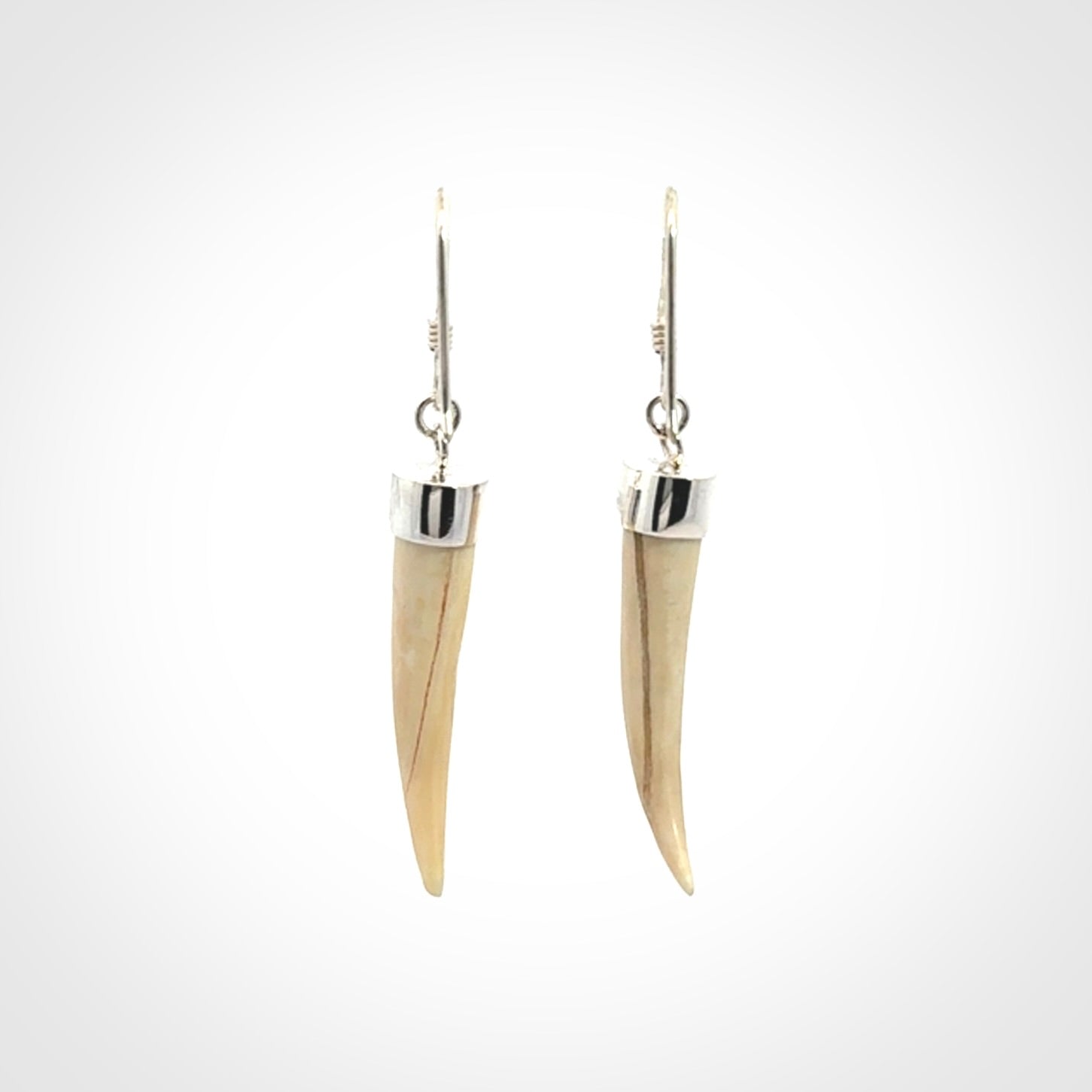Hand made mammoth tusk drop earrings. Made by NZ Pacific - handmade jewellery for sale online. Woolly Mammoth Tusk fang style earrings, packaged in a woven kete pouch.