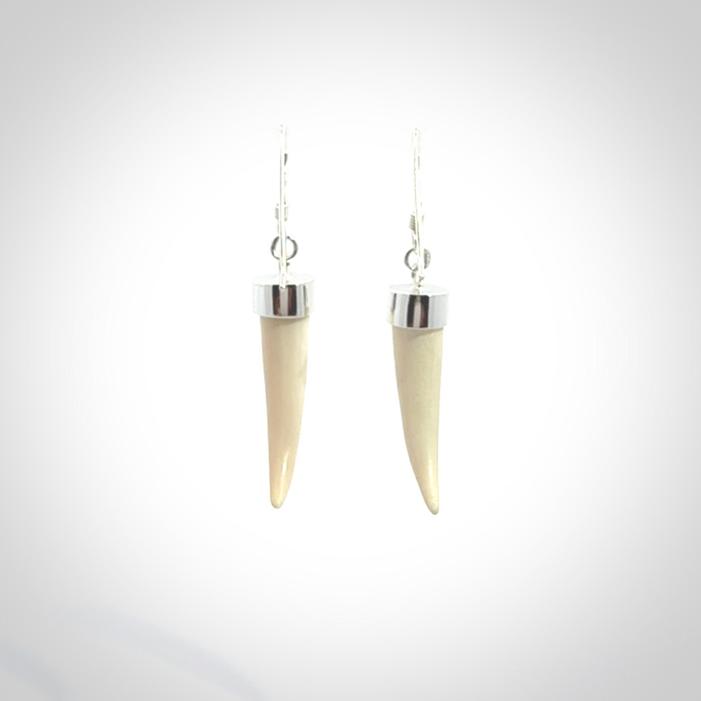 Hand made mammoth tusk drop earrings. Made by NZ Pacific - handmade jewellery for sale online. Woolly Mammoth Tusk fang style earrings, packaged in a woven kete pouch.