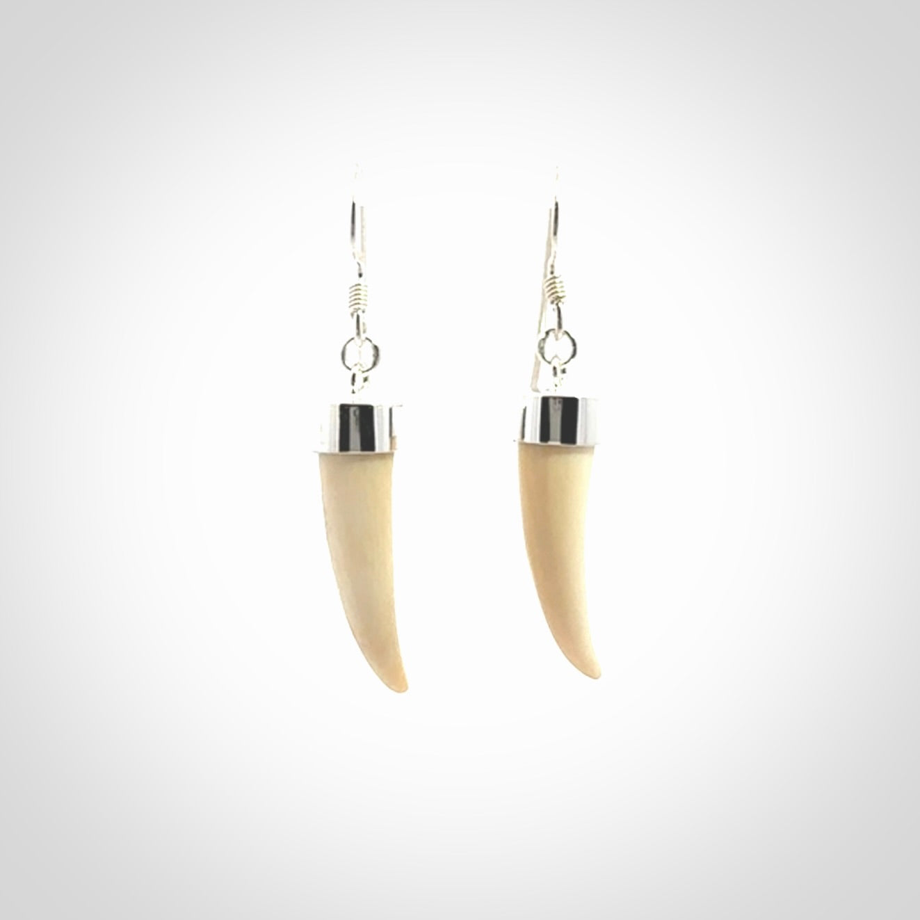 Hand made mammoth tusk drop earrings. Made by NZ Pacific - handmade jewellery for sale online. Woolly Mammoth Tusk fang style earrings, packaged in a woven kete pouch.