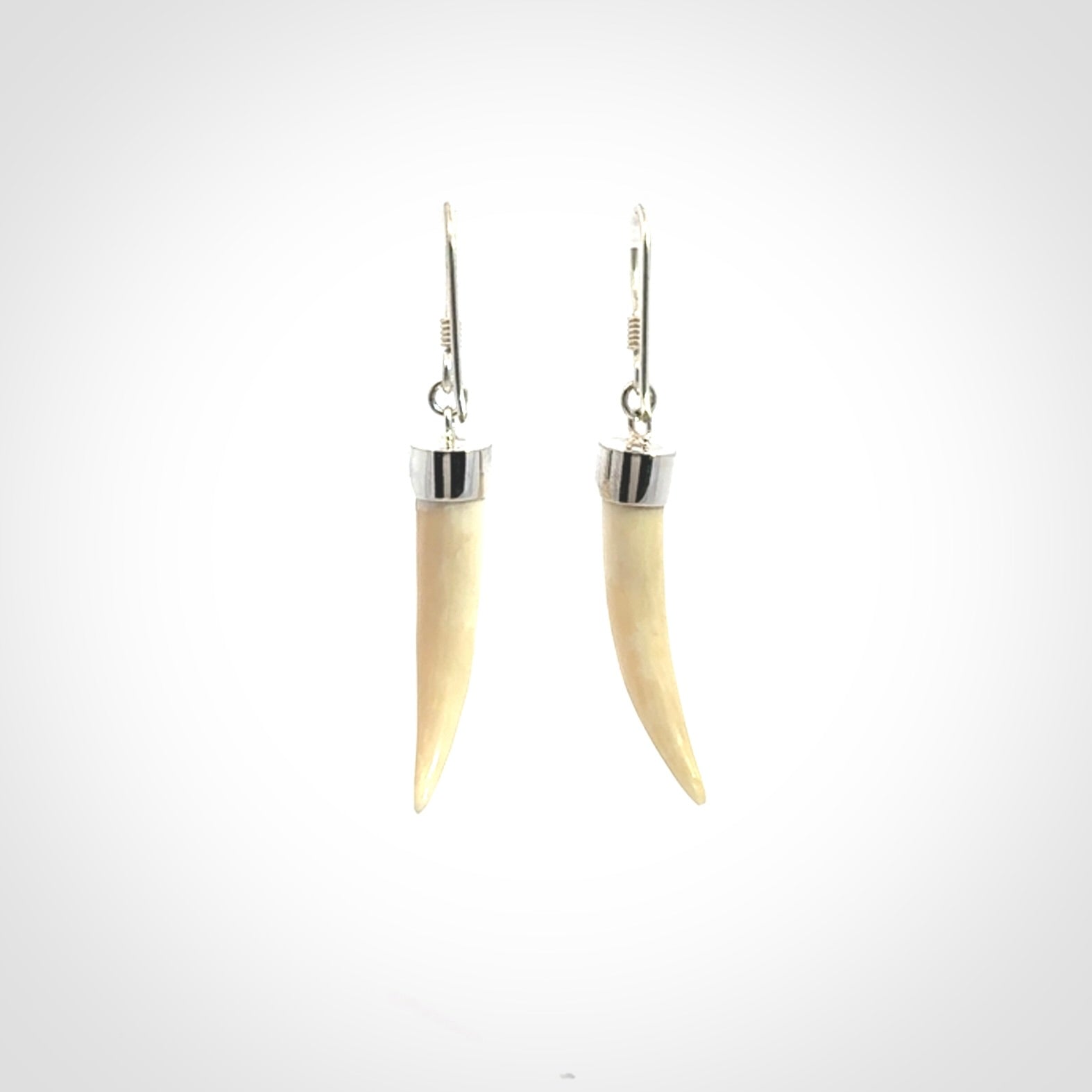 Hand made mammoth tusk drop earrings. Made by NZ Pacific - handmade jewellery for sale online. Woolly Mammoth Tusk fang style earrings, packaged in a woven kete pouch.