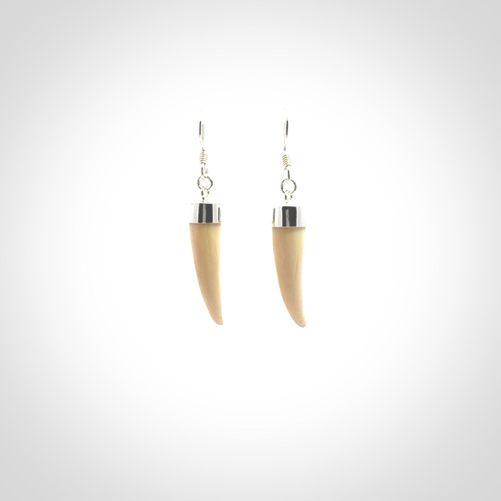 Hand made mammoth tusk drop earrings. Made by NZ Pacific - handmade jewellery for sale online. Woolly Mammoth Tusk fang style earrings, packaged in a woven kete pouch.
