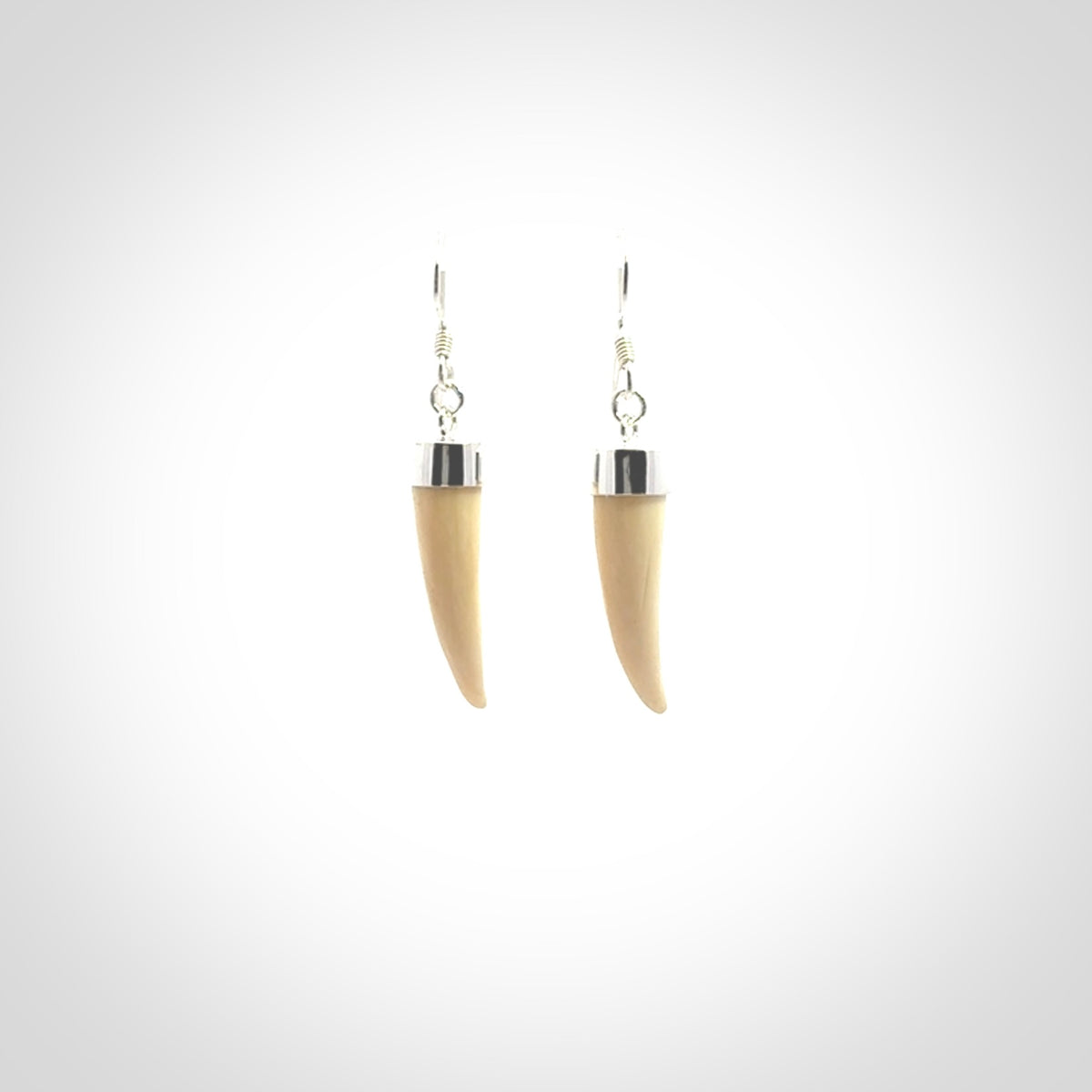 Hand made mammoth tusk drop earrings. Made by NZ Pacific - handmade jewellery for sale online. Woolly Mammoth Tusk fang style earrings, packaged in a woven kete pouch.