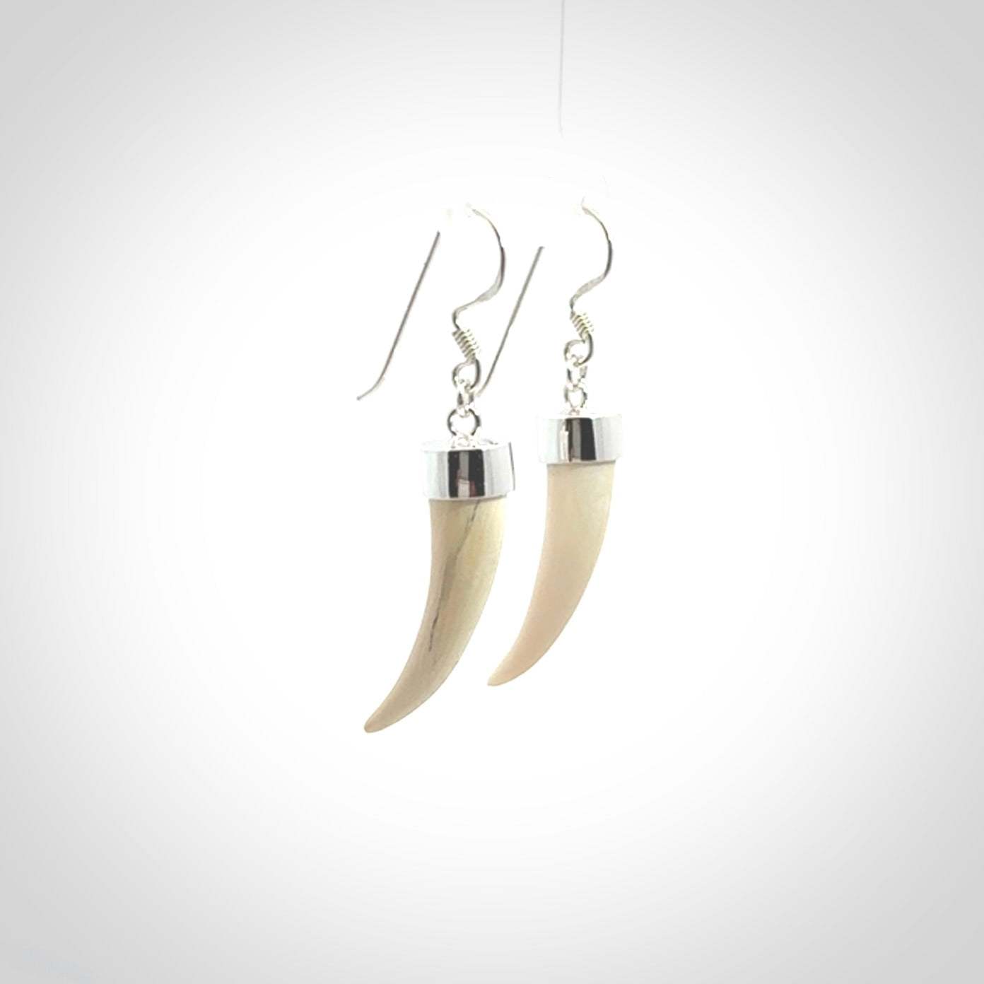 Hand made mammoth tusk drop earrings. Made by NZ Pacific - handmade jewellery for sale online. Woolly Mammoth Tusk fang style earrings, packaged in a woven kete pouch.