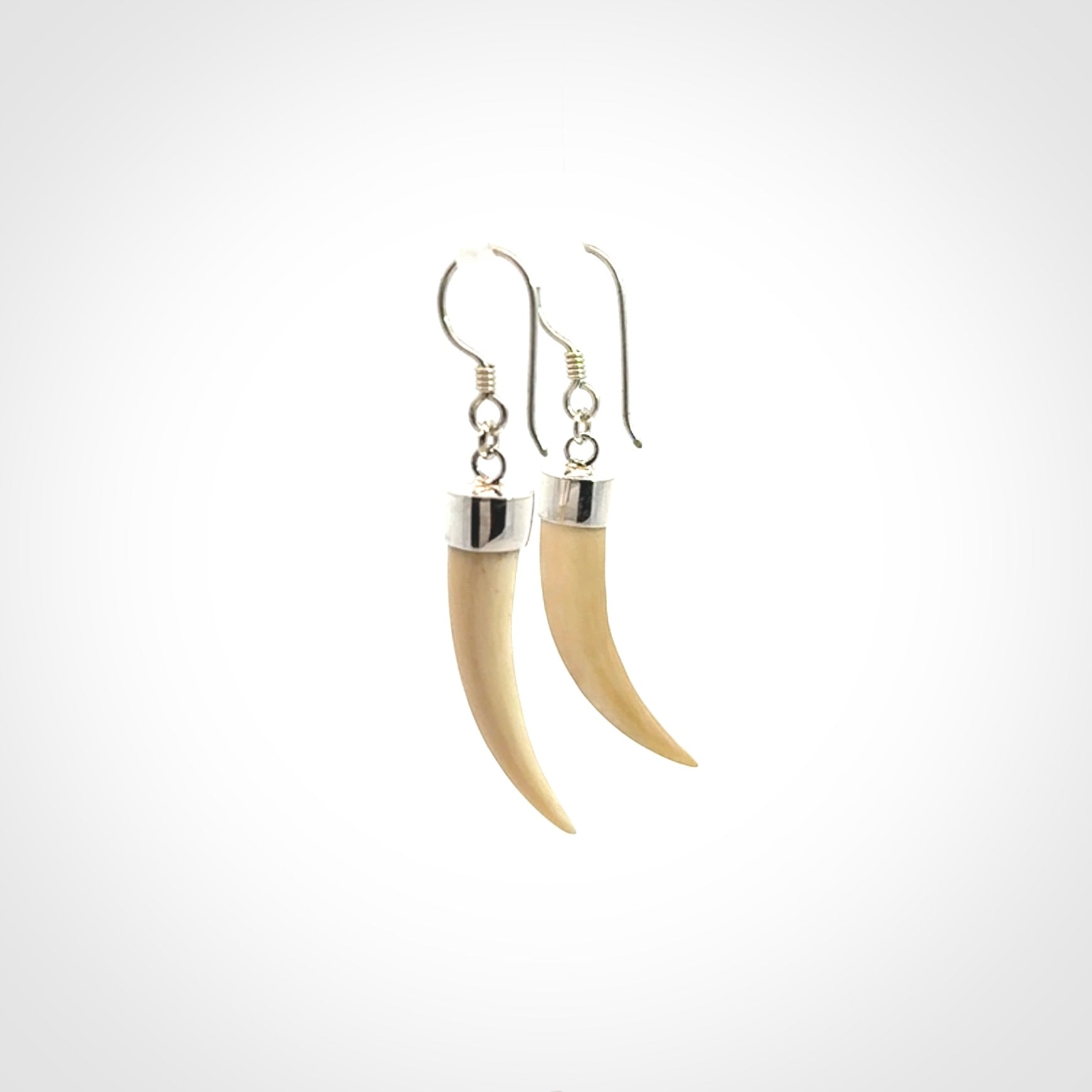 Hand made mammoth tusk drop earrings. Made by NZ Pacific - handmade jewellery for sale online. Woolly Mammoth Tusk fang style earrings, packaged in a woven kete pouch.