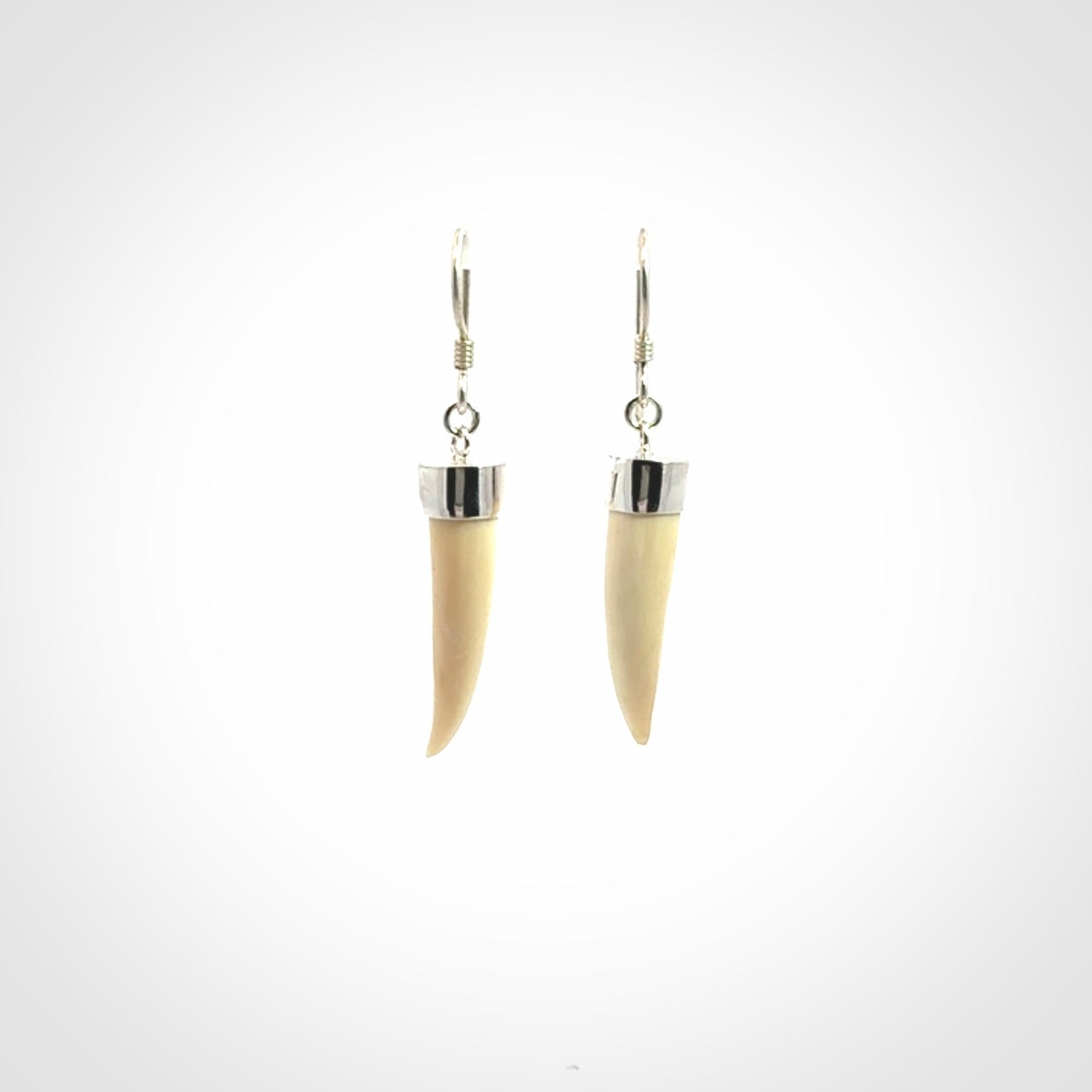 Hand made mammoth tusk drop earrings. Made by NZ Pacific - handmade jewellery for sale online. Woolly Mammoth Tusk fang style earrings, packaged in a woven kete pouch.