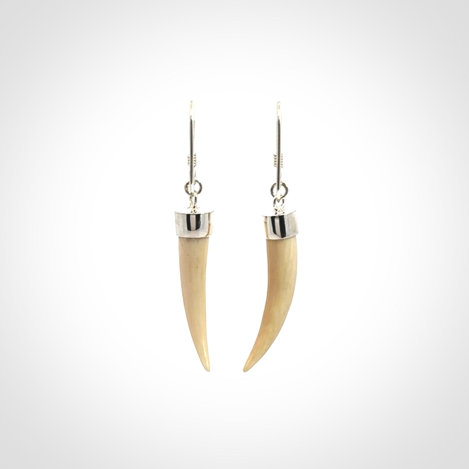 Hand made mammoth tusk drop earrings. Made by NZ Pacific - handmade jewellery for sale online. Woolly Mammoth Tusk fang style earrings, packaged in a woven kete pouch.