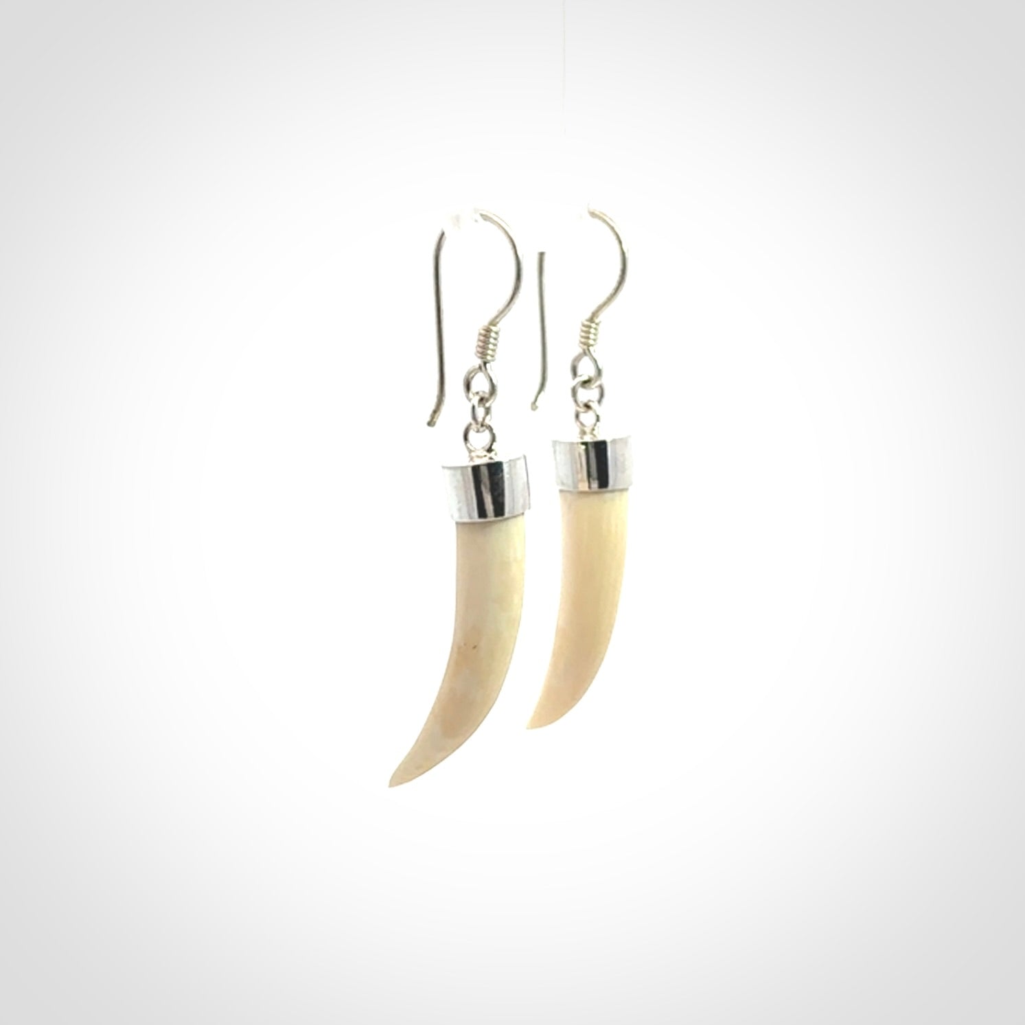 Hand made mammoth tusk drop earrings. Made by NZ Pacific - handmade jewellery for sale online. Woolly Mammoth Tusk fang style earrings, packaged in a woven kete pouch.