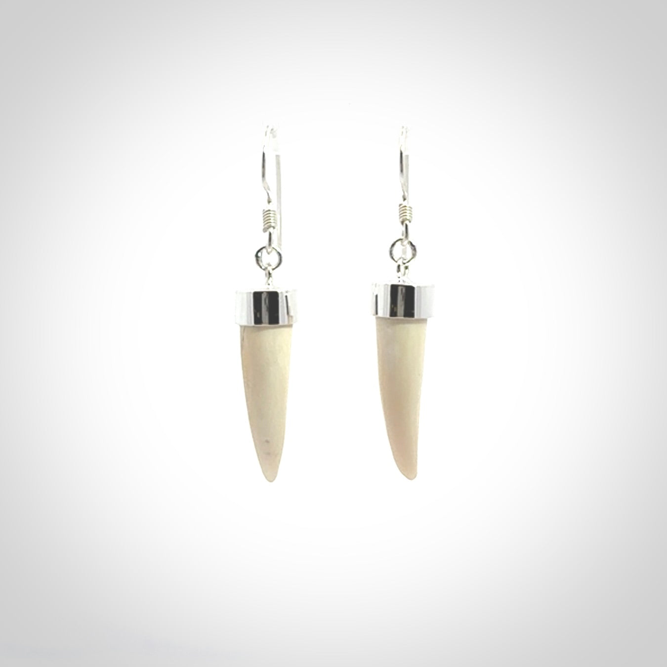 Hand made mammoth tusk drop earrings. Made by NZ Pacific - handmade jewellery for sale online. Woolly Mammoth Tusk fang style earrings, packaged in a woven kete pouch.