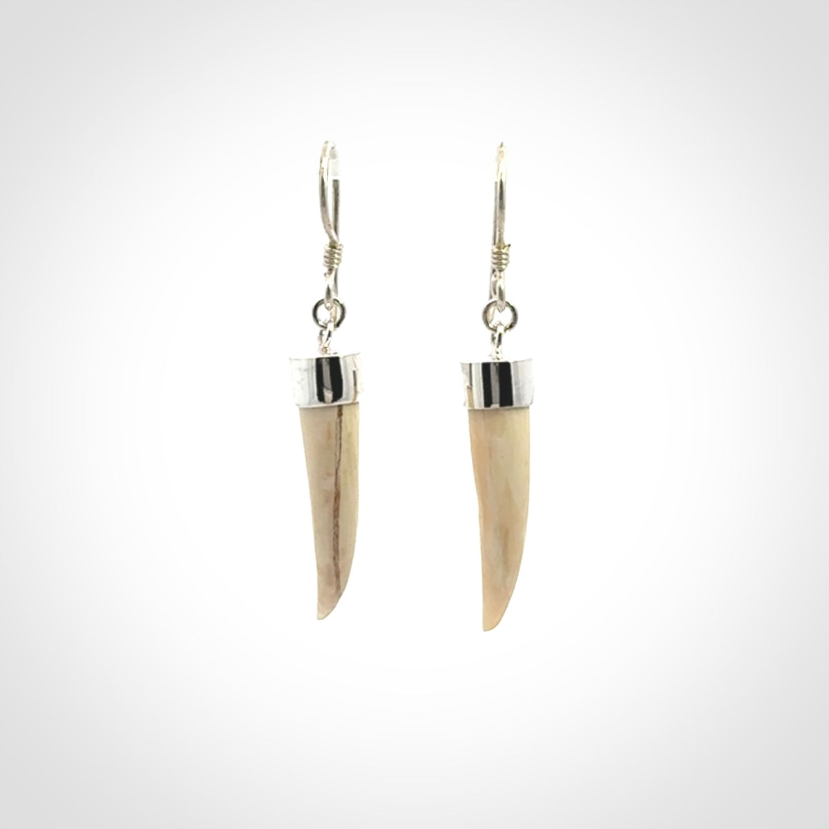 Hand made mammoth tusk drop earrings. Made by NZ Pacific - handmade jewellery for sale online. Woolly Mammoth Tusk fang style earrings, packaged in a woven kete pouch.