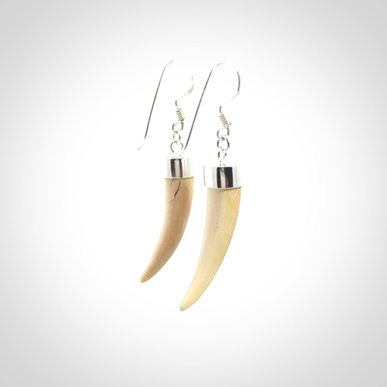 Hand made mammoth tusk drop earrings. Made by NZ Pacific - handmade jewellery for sale online. Woolly Mammoth Tusk fang style earrings, packaged in a woven kete pouch.