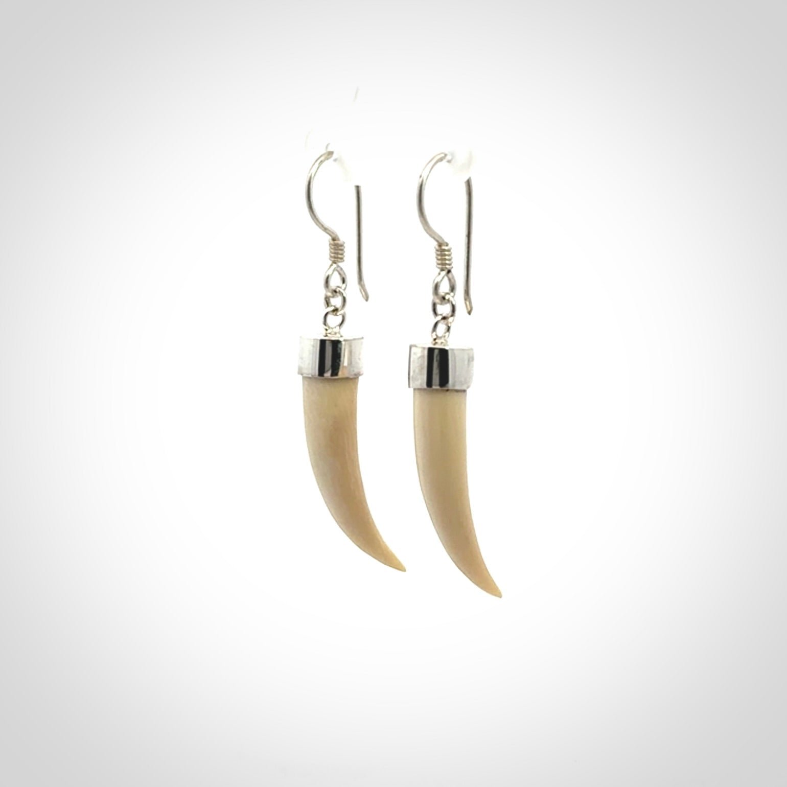 Hand made mammoth tusk drop earrings. Made by NZ Pacific - handmade jewellery for sale online. Woolly Mammoth Tusk fang style earrings, packaged in a woven kete pouch.