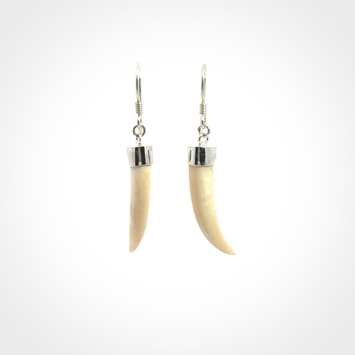 Hand made mammoth tusk drop earrings. Made by NZ Pacific - handmade jewellery for sale online. Woolly Mammoth Tusk fang style earrings, packaged in a woven kete pouch.