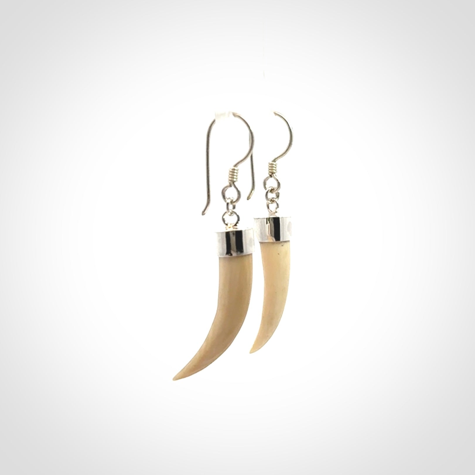 Hand made mammoth tusk drop earrings. Made by NZ Pacific - handmade jewellery for sale online. Woolly Mammoth Tusk fang style earrings, packaged in a woven kete pouch.
