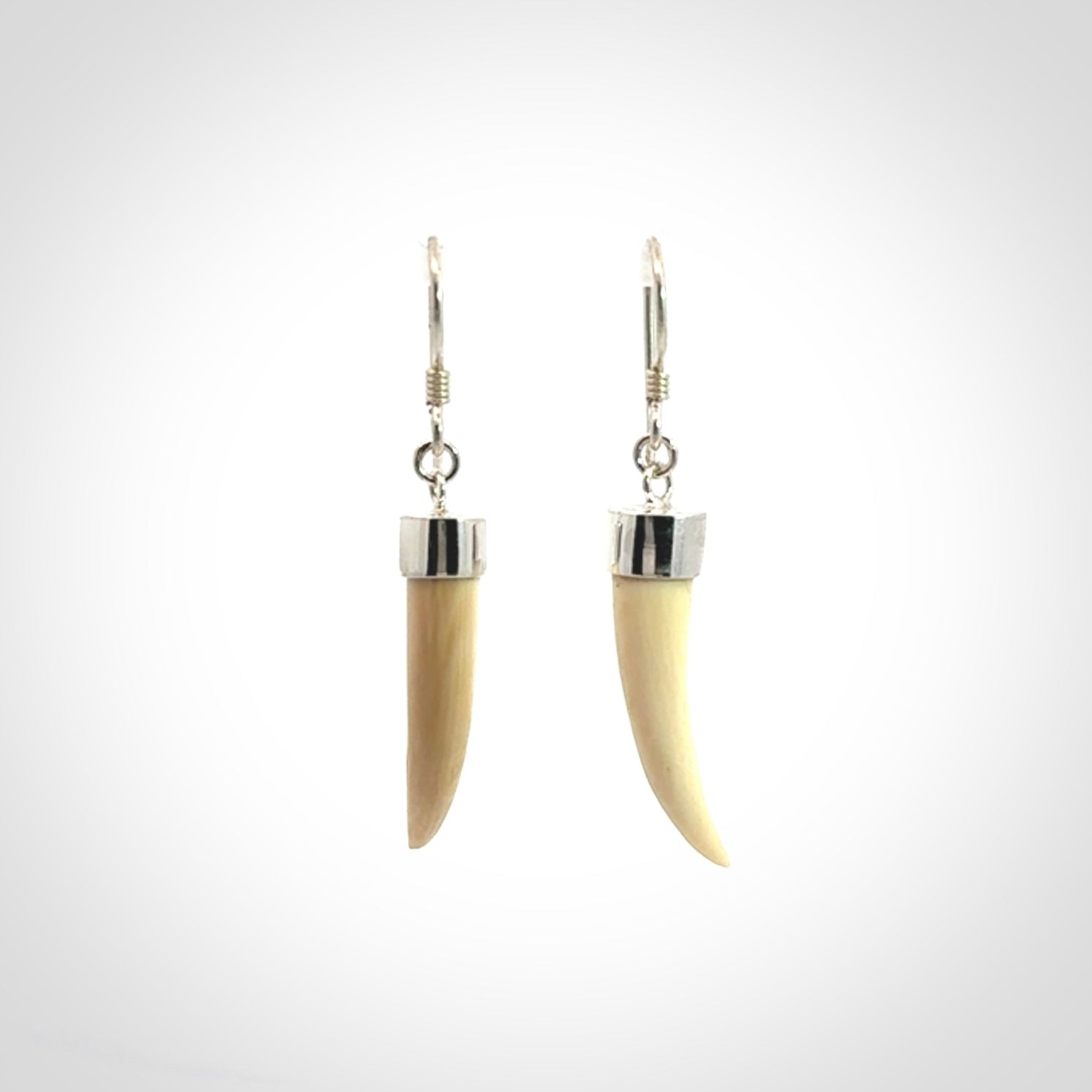 Hand made mammoth tusk drop earrings. Made by NZ Pacific - handmade jewellery for sale online. Woolly Mammoth Tusk fang style earrings, packaged in a woven kete pouch.