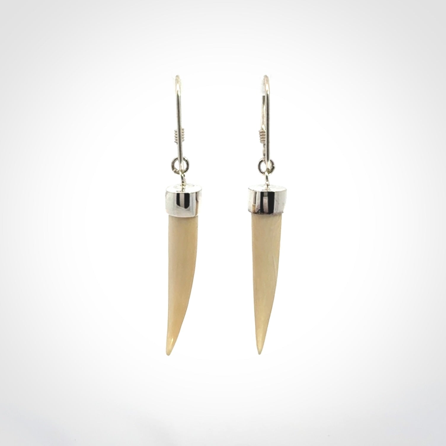 Hand made mammoth tusk drop earrings. Made by NZ Pacific - handmade jewellery for sale online. Woolly Mammoth Tusk fang style earrings, packaged in a woven kete pouch.