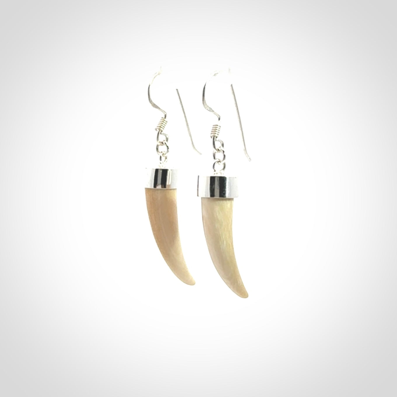 Hand made mammoth tusk drop earrings. Made by NZ Pacific - handmade jewellery for sale online. Woolly Mammoth Tusk fang style earrings, packaged in a woven kete pouch.
